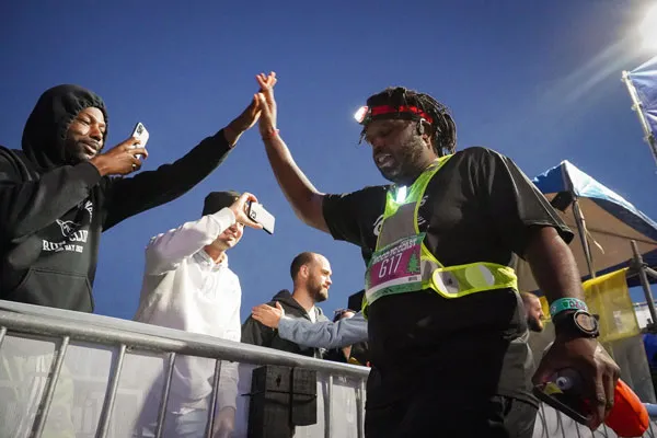 A racer high-fiving a supporter