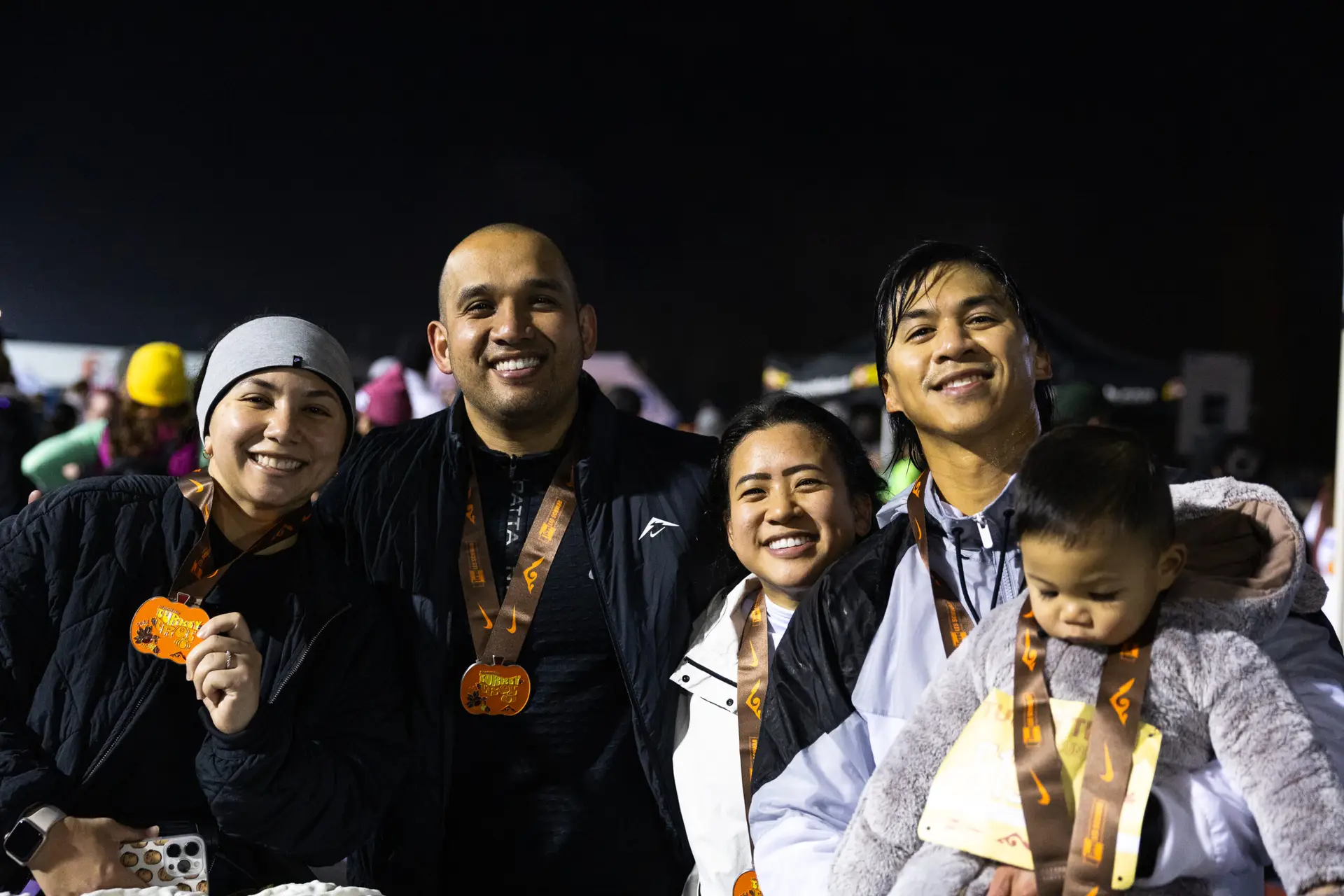 HTC Turkey Trot finishers smiling with medals