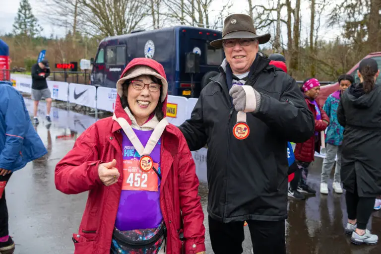 A couple smiling with medals